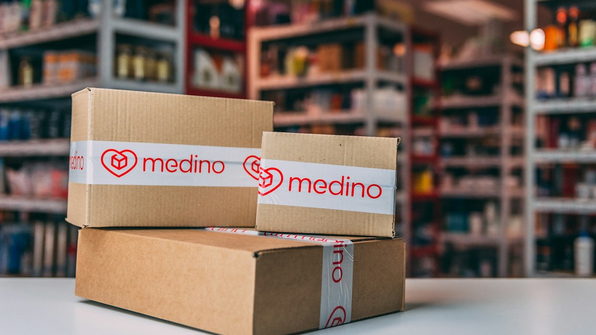 Cardboard delivery boxes sit in front of shelves.